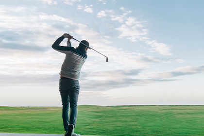 Man golfing at Harmony Calgary Golf course